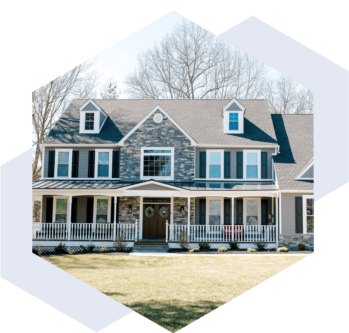 re-img-2 Large stone and siding house with a spacious porch and dormer windows.