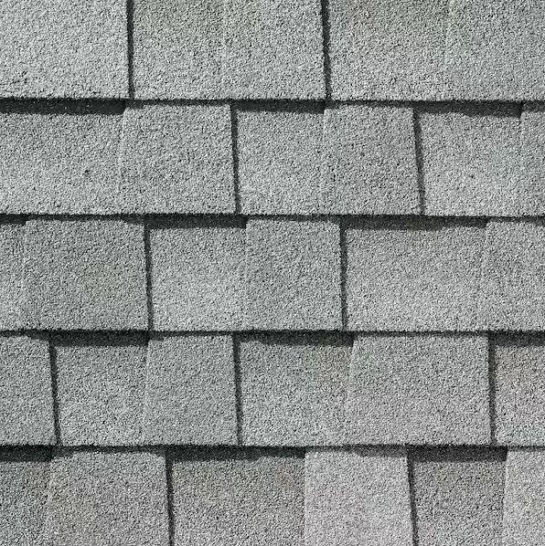 Fox hollow gray A close-up of gray asphalt roof shingles arranged in rows.