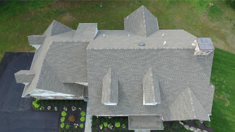 roofing contractor springfield pa Aerial view of a gray rooftop with two dormer windows.